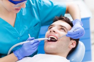 man having teeth examined at dentist