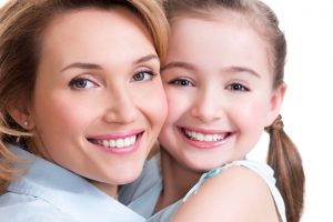 happy mom and daughter with beautiful smiles